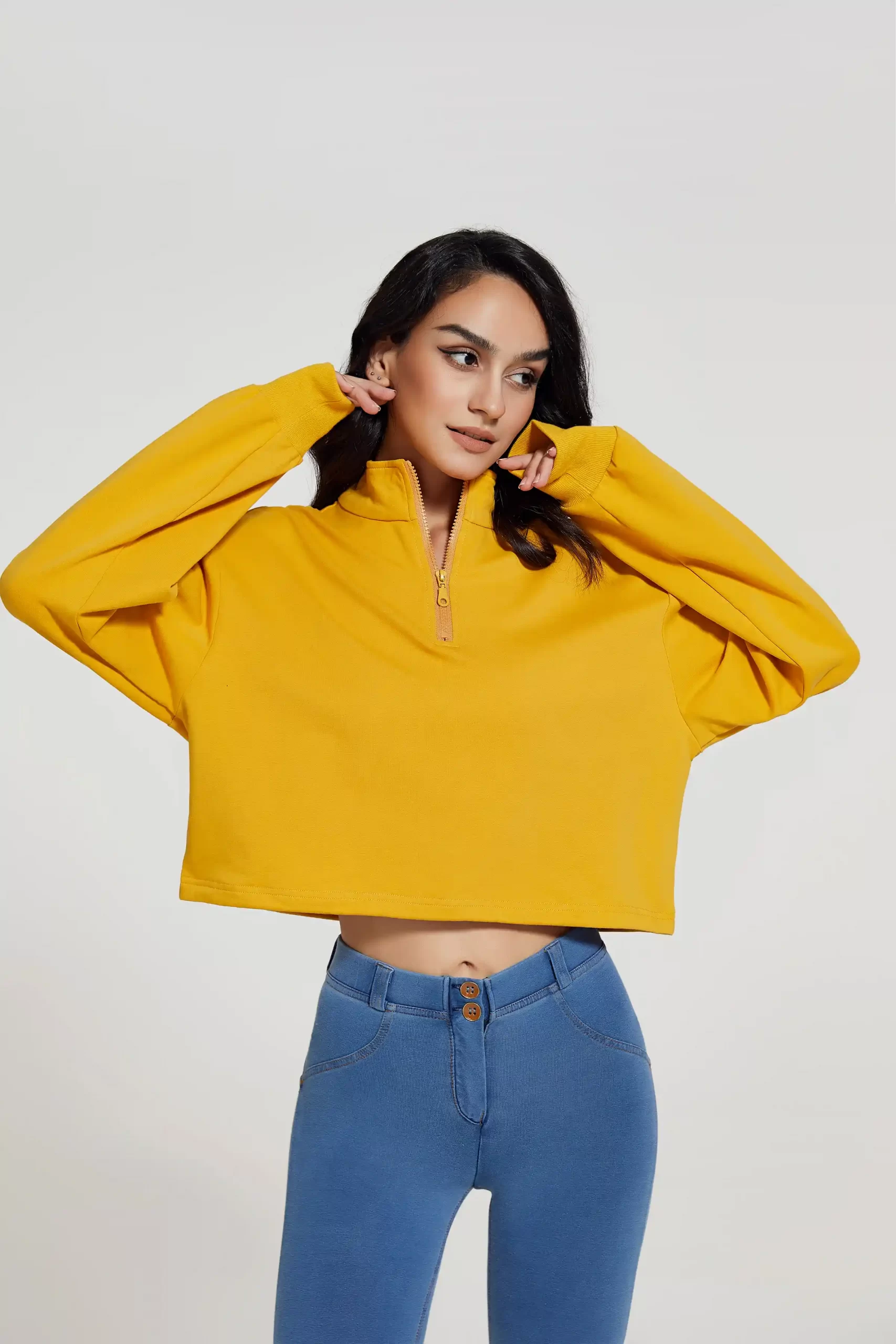 Fashionable women’s activewear featuring loose-fit yellow top and blue leggings, highlighting stretch fabric and body contour