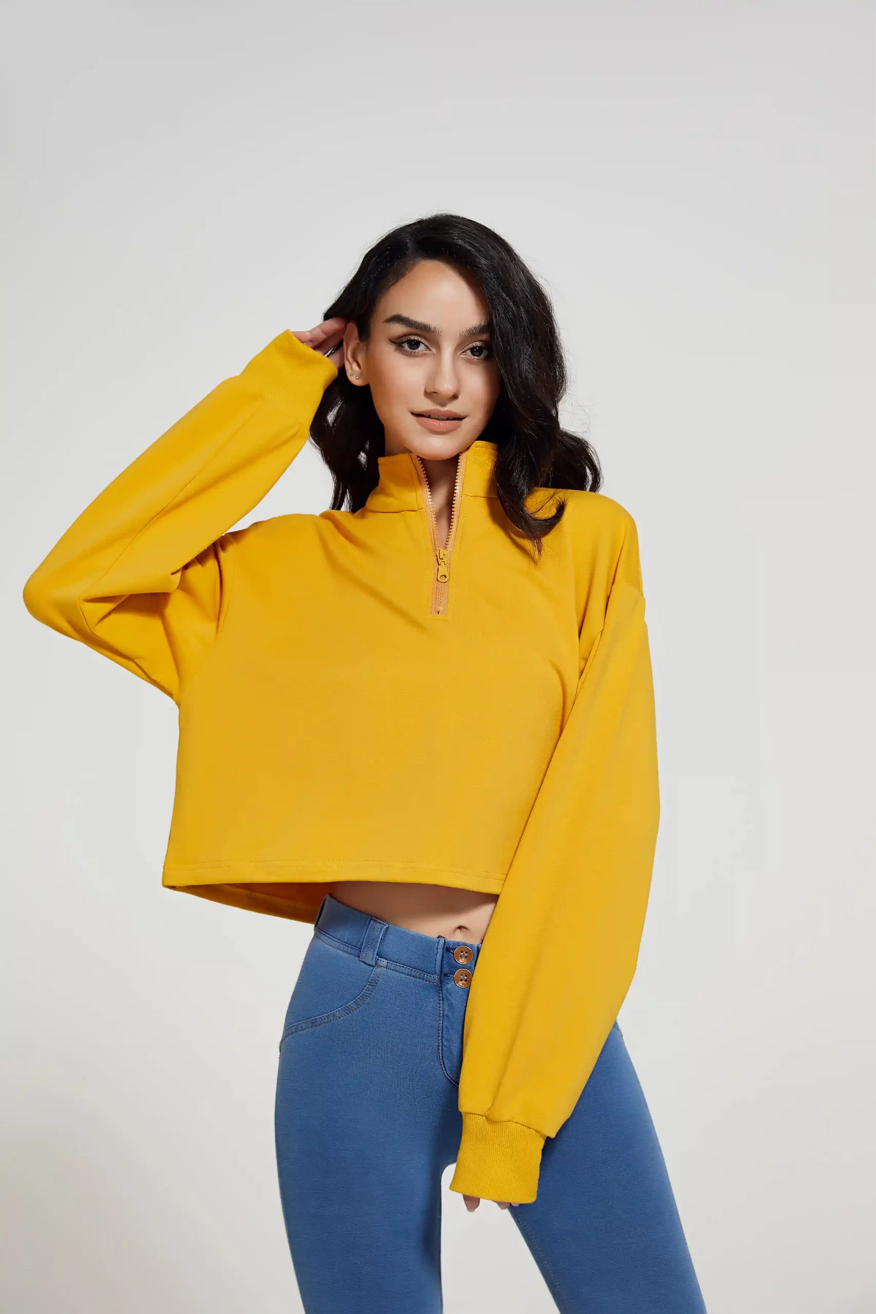 Front view of a woman wearing yellow cropped sports pullover paired with tummy control leggings, ideal for custom activewear line
