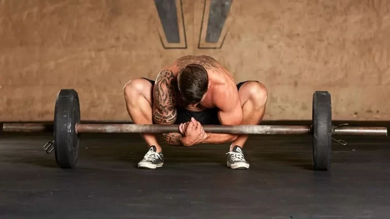 Man demonstrating an unconventional barbell exercise hack to improve grip strength and posture.