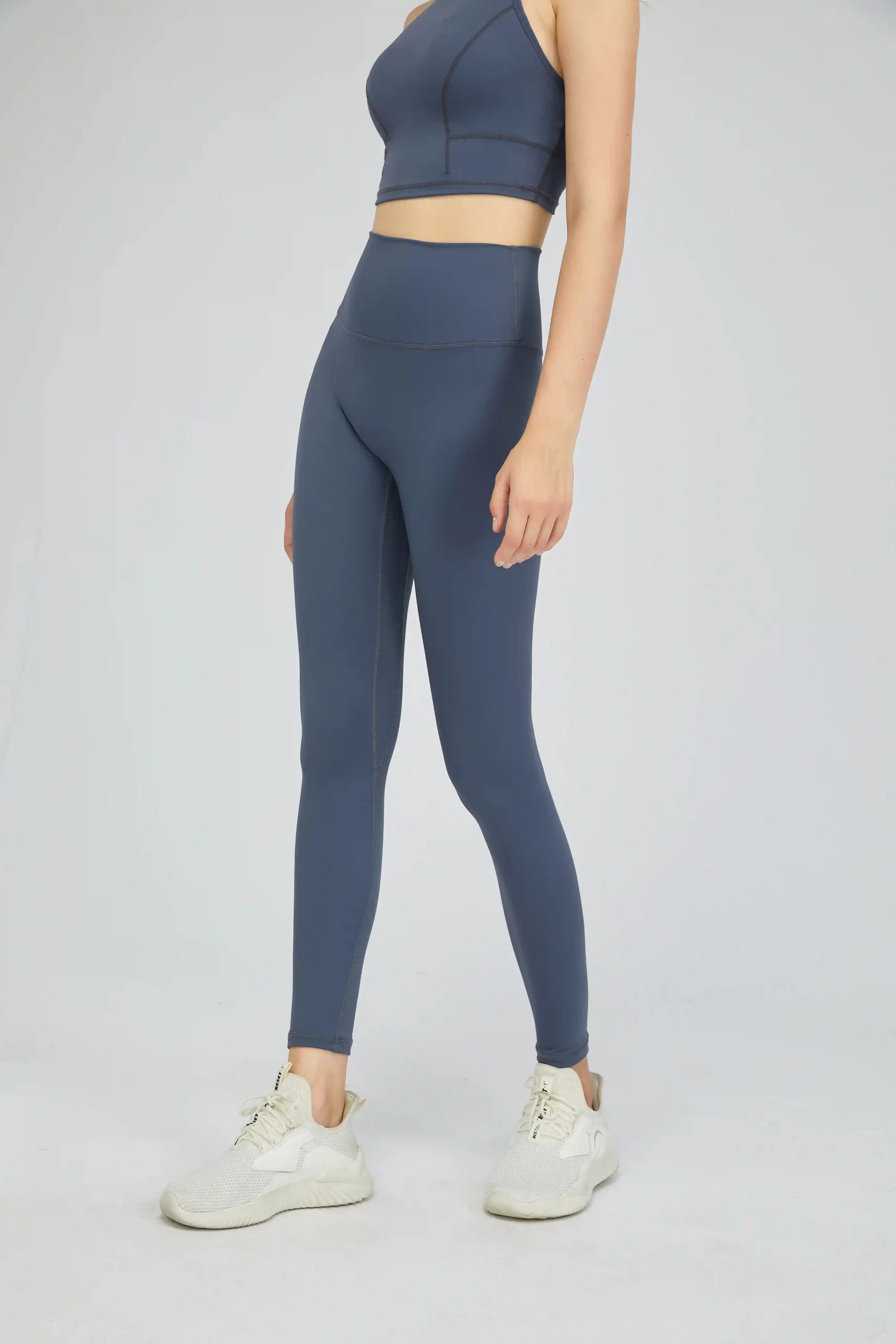 woman wearing high-waist grey yoga tights during workout