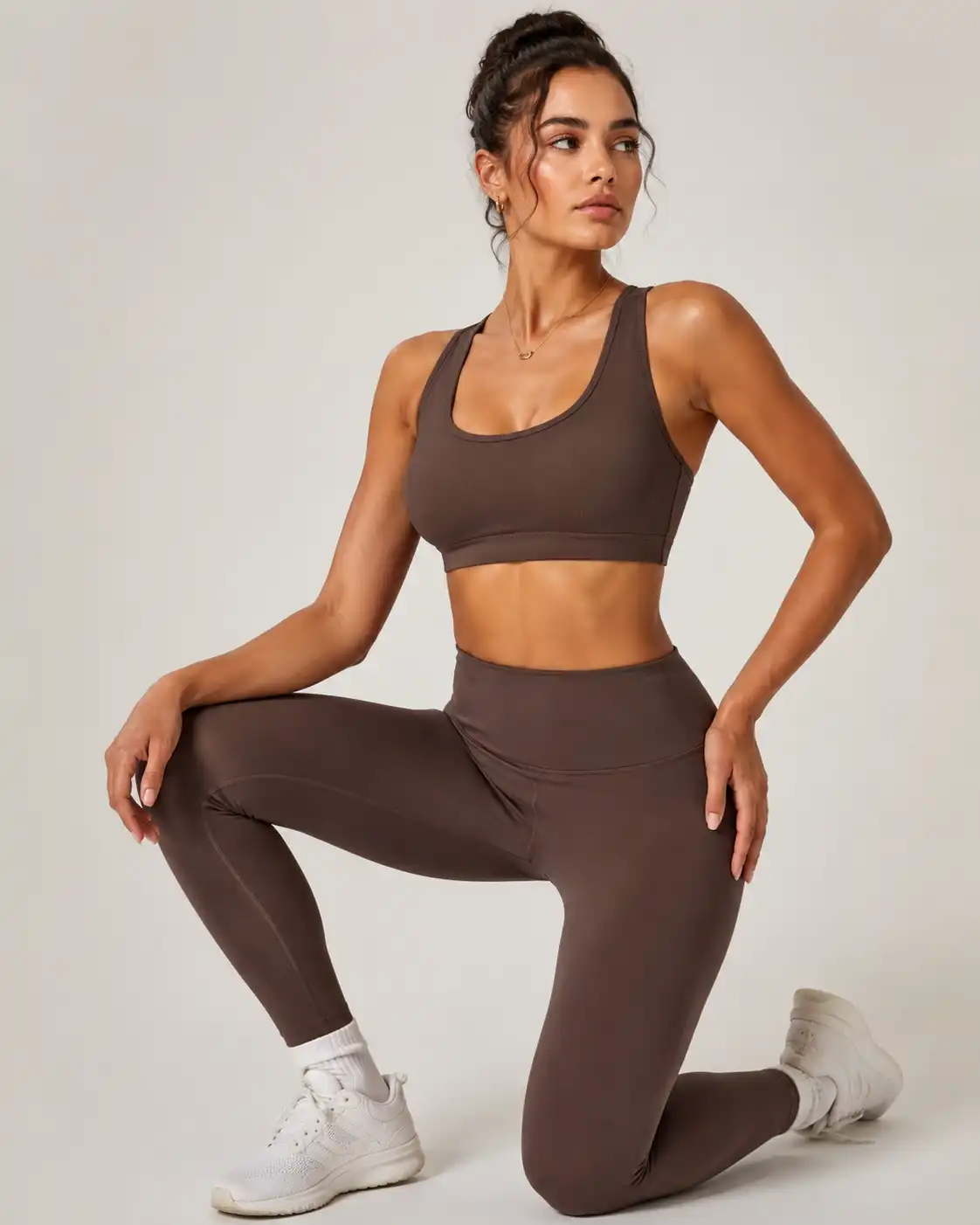 Model wearing a chocolate brown custom activewear set with a sports bra and high-waist leggings